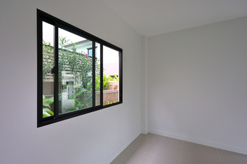 glass slide window replacement on white wall of a new house