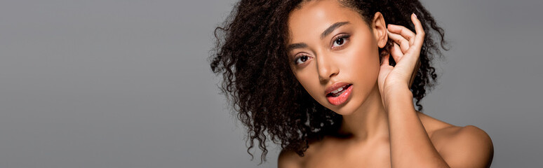 panoramic shot of nude curly african american girl, isolated on grey