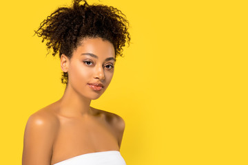 Wall Mural - portrait of african american girl with perfect skin, isolated on yellow