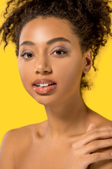 Wall Mural - portrait of naked african american girl with clean face, isolated on yellow