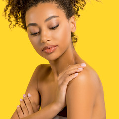 Wall Mural - portrait of tender african american girl with clean face, isolated on yellow