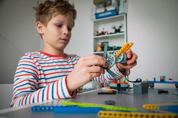 Poster - child building robot at robotic technology school lesson