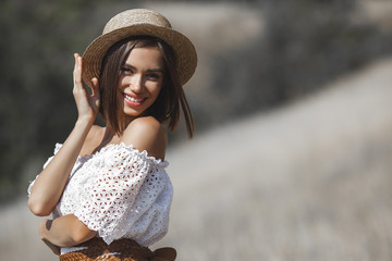 Attractive young woman catching the sunlight. Female outdoors. Lady on wild nature. Freedom.