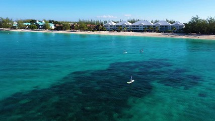 Wall Mural - aerial drone footage of seven mile beach, west bay and george town on the island of grand cayman in the cayman islands in the clear blue and green tropical waters of the caribbean sea