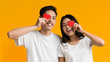 © Prostock-studio - Happy asian couple covering one eye with valentine cards