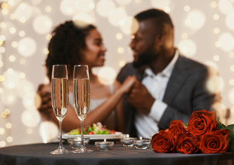 Wall Mural - African american couple in love cuddling in restaurant