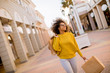 © BGStock72 - Young black woman with curly hair in shopping