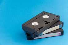 Several VHS Video Cassettes, On A Blue Background.