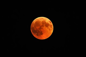 Wall Mural - Beautiful shot of a red moon, total lunar eclipse with a black night sky in the background