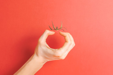 Invisible tomato. Creative concept. Illusion. Red background.