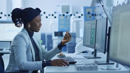 Poster - Electronics Factory: Female Electrical Engineer Holds PCB Prototype, Works on Computer, uses CAD Software to Develop Microchips, Semiconductor and Telecommunications Equipment. Manufacturing Facility