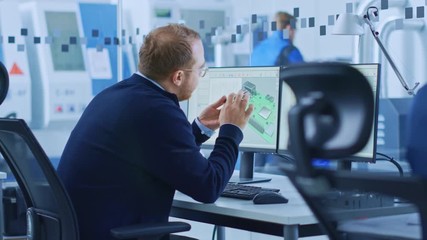Poster - Electronics Factory: Male Electrical Engineer Holds PCB Prototype, Works on Computer, uses CAD Software to Develop Microchips, Semiconductor and Telecommunications Equipment. Manufacturing Facility