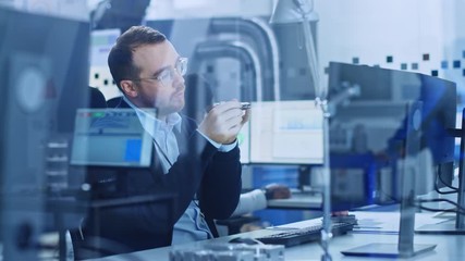 Poster - Electronics Factory: Male Electrical Engineer Holds PCB Prototype, Works on Personal Computer, Develop Microchips, Semiconductor and Telecommunications Equipment. Manufacturing Facility