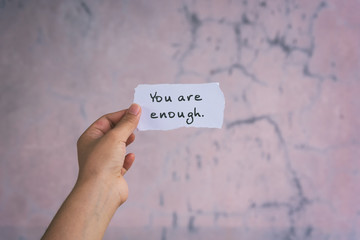 Motivation and inspirational quotes - You are enough. Blurry background.