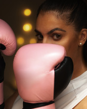 Woman Boxing With Pink Gloves On A Black Background