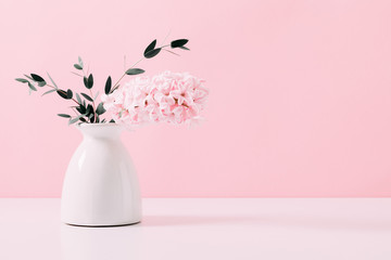 Pink hyacinth, eucalyptus on pink wall background. Spring flower hyacinth in vase on pink background.