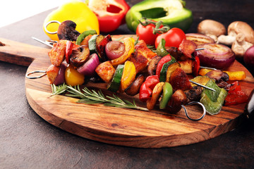 Wall Mural - Grilled pork shish or kebab on skewers with vegetables . Food background shashlik