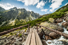 Cloudy Mountain Landscape With Wood Bridge For Hiking And Water Cascades During The Day In High Tatras, Slovakia