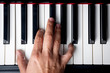 right hand playing a A Minor inversion chord on the piano