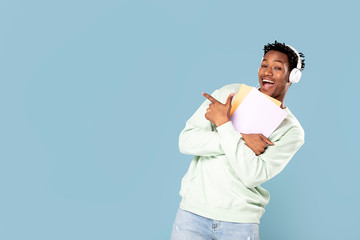 Wall Mural - Happy african student posing in studio.