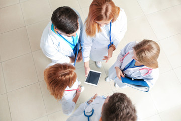 Canvas Print - Doctors discussing something in hall of clinic, top view