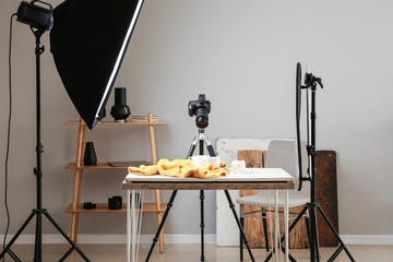 Wall Mural - Interior of modern photo studio with professional equipment and drink on table