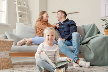 Sticker - Cute little girl with parents resting at home