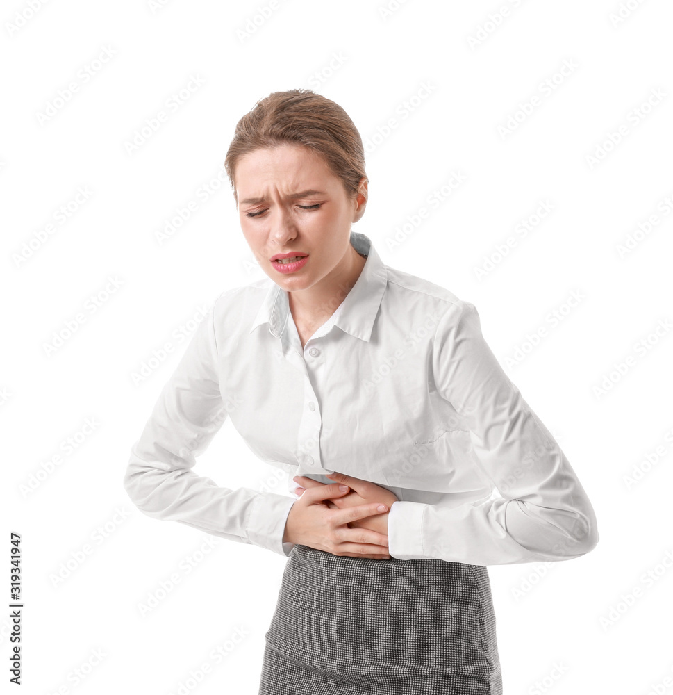 Young businesswoman suffering from abdominal pain on white background