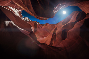 Wall Mural - Antelope Canyon's red rock formations under a midnight blue evening sky in Page, Arizona, USA.