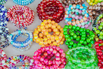 Wall Mural - The colorful stone is used to make beautiful bracelets. Is a religious belief of Thai people that will have good luck for sale on the local market in Kanchanaburi, Thailand. Selective focus.