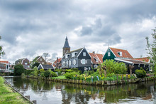 View Of Canal, Bridge And Traditional Wooden Fishing Houses In Waterland Village Marken, Netherlands. Traditional Holland Symbols - Canal, Wooden Houses, Bridge
