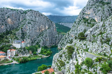 Wall Mural - View of Cetina River, mountains and old town Omis, Croatia. Cetina river canyon and mouth in Omis view from above, Dalmatia region of Croatia