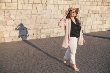 Plus size model wearing fashion clothes in city street