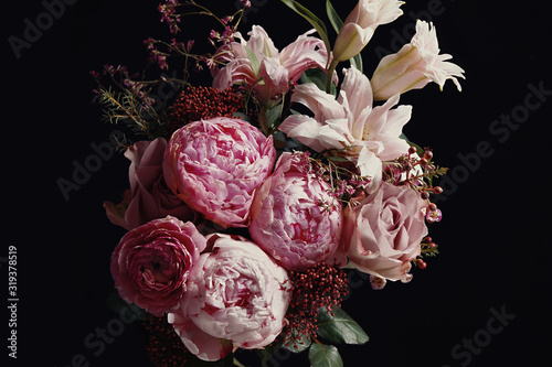 Beautiful bouquet of different flowers on black background. Floral card design with dark vintage effect