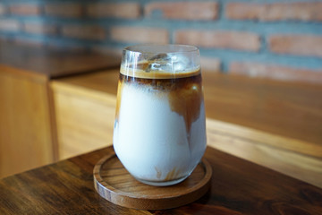 Close up glass of iced coffee latte on wooden tray table