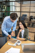 © zinkevych - Two employees working in the office and looking involved