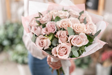 Beautiful Bouquet Of Pastel Roses In Womans Hands. The Work Of The Florist At A Flower Shop. Delivery Fresh Cut Flower. European Floral Shop.