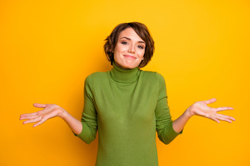 Poster - I don't know. Photo of beautiful lady spread hands shrug shoulders careless ignorance expression said bad wrong thing wear casual green turtleneck isolated yellow color background