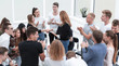 © ASDF - young people shaking hands in a circle of like-minded people