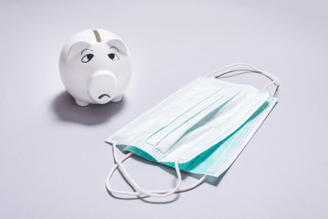 Wall Mural - Sad piggy bank and set of Medical disposable masks