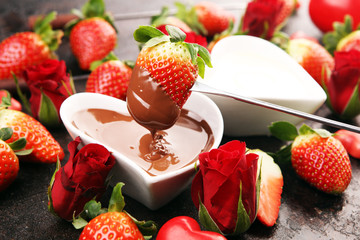 Wall Mural - Valentine Chocolate fondue melted with fresh strawberries and dark and white chocolate. Red roses and sugar hearts for Valentines Day. Valentine Background