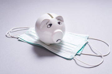 Sad piggy bank and set of Medical disposable masks