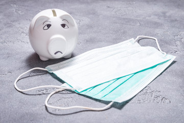 Wall Mural - Sad piggy bank and set of Medical disposable masks