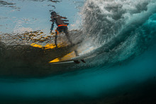 Underwater View Of The Surfer Riding The Wave