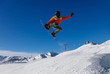 © Alexey Kuznetsov - Snowboarder does a jumping trick in the snow Park