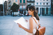 © BullRun - Cheerful tourist with map looking away