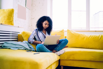 African American woman using laptop at home