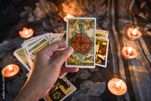Hand holding tarot card with candlelight on the darkness background for Astrolog Tableau sur Toile