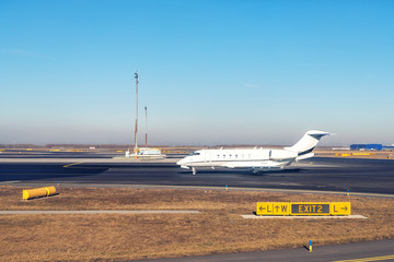 Mid size modern vip private jet running on rairport runway ready to departure. Pilot asking air traffic control officer for take-off clearance. Luxury small corporate business aircraft trip