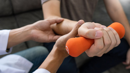 Physiotherapist working with patient doing with exercise, physical therapy concept.